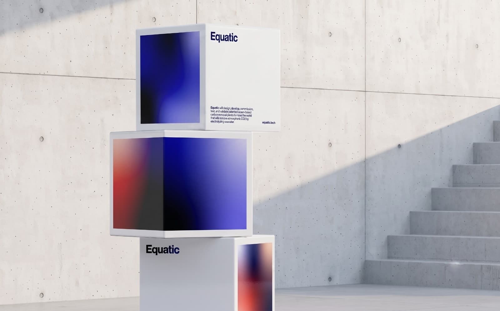 Stacked launch cubes carrying a brand identity system in a concrete hall